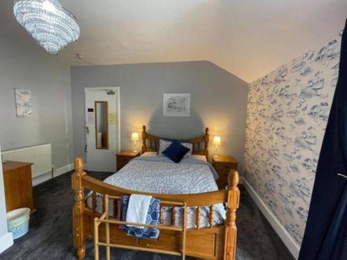a bedroom with a wooden bed in a room at Seascape in Barmouth