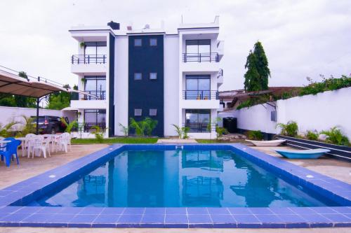 an image of a swimming pool in front of a building at Volume view Apartments in Mombasa