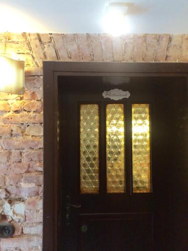a black door with a brick wall at Bergbach in Ramsau
