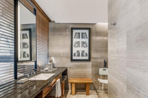 a bathroom with a sink and a mirror at Grand Fiesta Americana Monterrey Valle in Monterrey