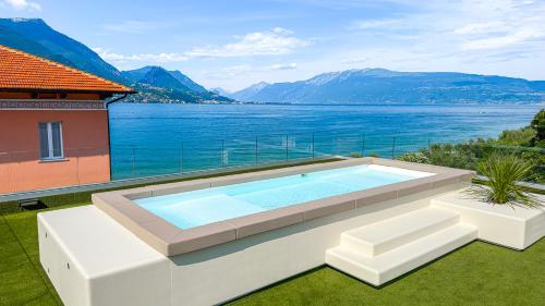 a swimming pool with a view of the water at Park Hotel Casimiro in San Felice del Benaco