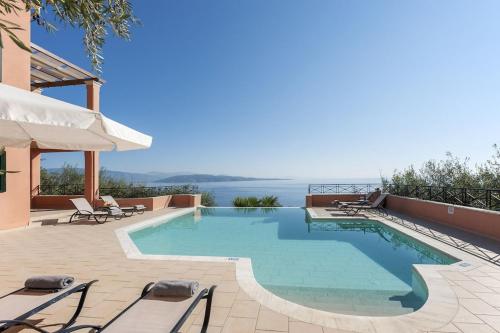 a swimming pool with a view of the water at Villa Kyma, Kaminaki Villas in Corfu With Private Pool And Spectacular Sea Views in Agní