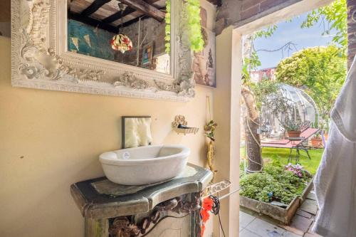 a bathroom with a bowl sink on a table with a window at Sky Room - Carrara Bubble Room Tuscany Nel ex Convento delle Suore in Carrara