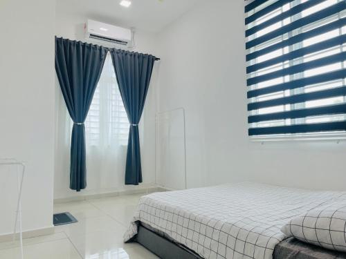 a bedroom with a bed and a window with blue curtains at Anjung Rindu Homestay (Kuala Terengganu, UMT, UniSZA) in Kuala Terengganu