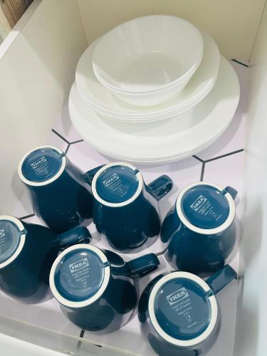 a group of cups and plates in a drawer at Anjung Rindu Homestay (Kuala Terengganu, UMT, UniSZA) in Kuala Terengganu