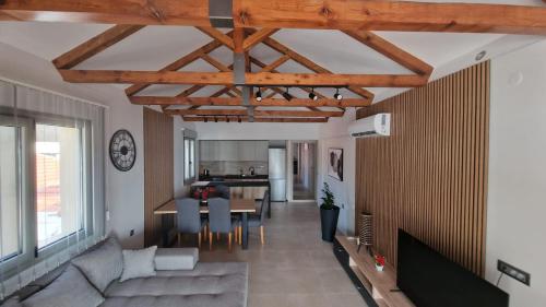 a living room with a couch and a table at VIEW ON SCORPIOS - Ktena Accomodation in Nydri