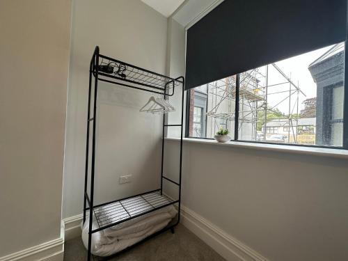 an empty room with a shower in the corner with a window at Luxury apartment stay in Cardiff