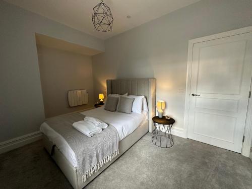 a bedroom with a bed with two towels on it at Luxury apartment stay in Cardiff