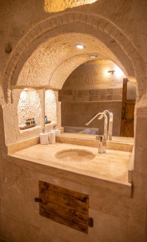 a bathroom with a sink in a stone room at Arif Cave Hotel in Goreme
