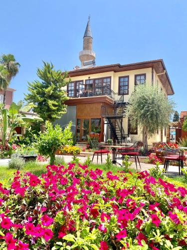 a house with a lot of flowers in front of it at Necip Bey Konağı in Antalya