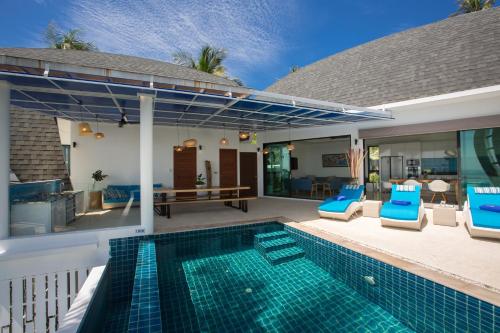 a villa with a swimming pool and a patio at Villa La Moon Chaweng Noi 4BR in Koh Samui 