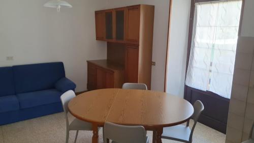 a living room with a table and a blue couch at appartamento Cortellini in Pellizzano