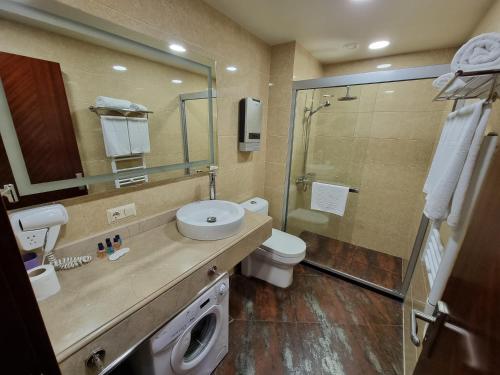 a bathroom with a shower and a sink and a toilet at Dreamland Oasis in Chakvi in Chakvi