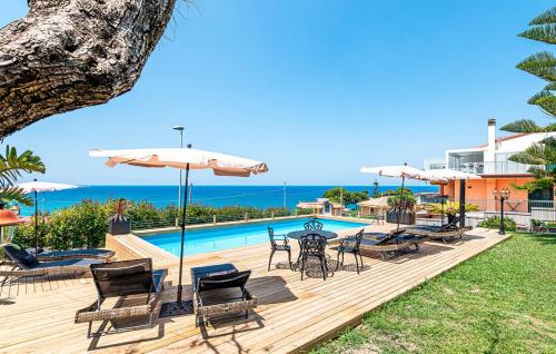 a patio with a table and chairs and a pool at MaryWilliam in Agropoli