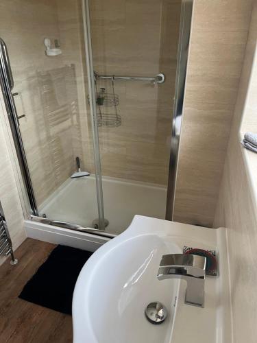 a bathroom with a white sink and a shower at Church View in Weston Subedge