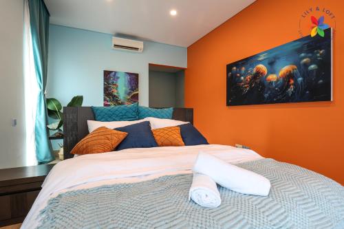 a bedroom with a bed with an orange wall at Private Studio in Bungalow by LilyandLoft in Subang Jaya