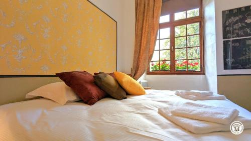 a bed with towels on it with a window at L'Auditoire Royal in Châtillon-sur-Seine