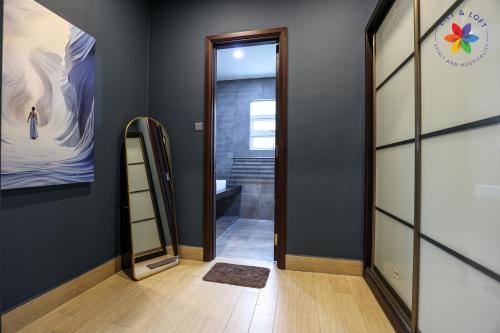 a hallway with a mirror and a stairway at Private Studio in Bungalow by LilyandLoft in Subang Jaya