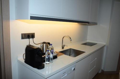 a kitchen counter top with a sink and a sink at Yalinn Boutique Hotel in Yalıkavak