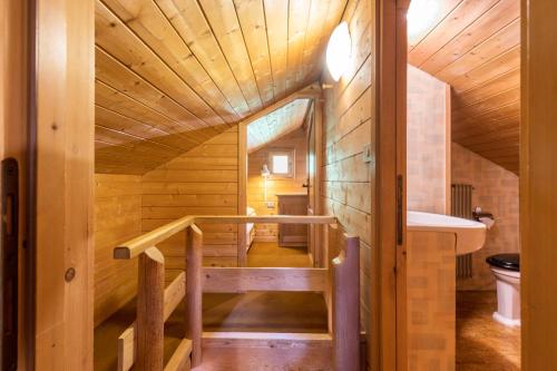 a tree house with a bathroom and a sink at Baita Pecol Passo Pordoi in Canazei