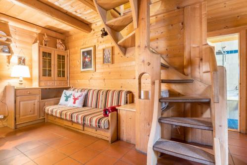 a log cabin living room with a bench at Baita Pecol Passo Pordoi in Canazei