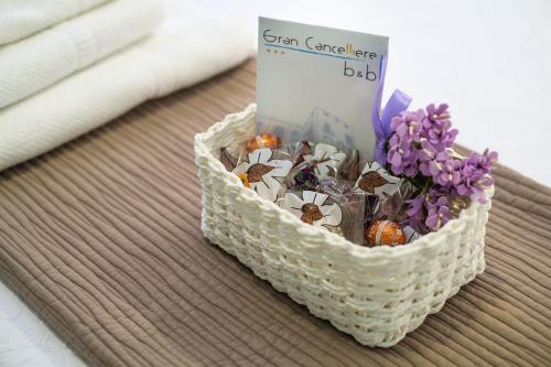 a basket of flowers and a book on a table at Gran Cancelliere B&B in Palermo