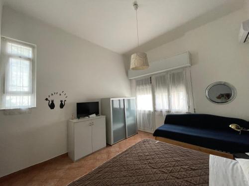a bedroom with a blue bed and a television at Milano Canal Apartments in Milan