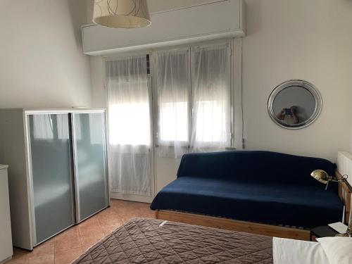 a bedroom with a blue bed and a window at Milano Canal Apartments in Milan