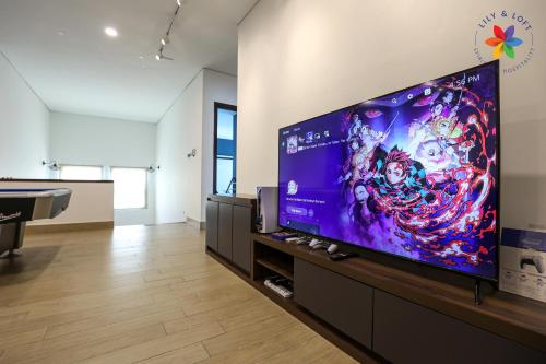a living room with a large flat screen tv at Private Studio in Bungalow by LilyandLoft in Subang Jaya