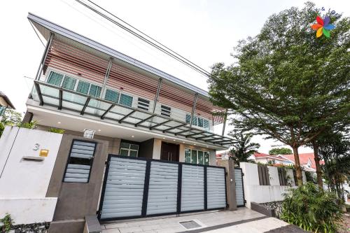 a house with a gate in front of it at Private Studio in Bungalow by LilyandLoft in Subang Jaya