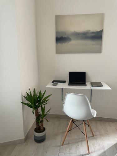 a white desk with a laptop and a chair at Dama Dama in Guardiagrele