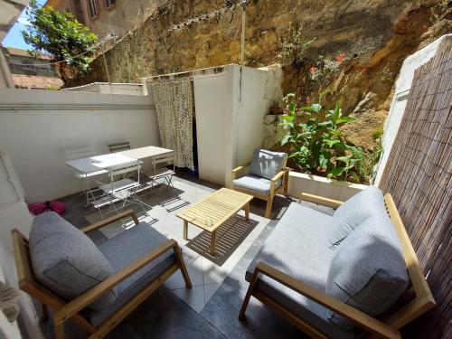 d'une terrasse avec deux chaises, une table et une table. dans l'établissement Gretta - Patio, Cosy, WiFi - Ajaccio, à Ajaccio