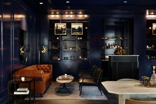 a living room with a couch and a table at Kimpton - The Forum Hotel by IHG in Charlottesville