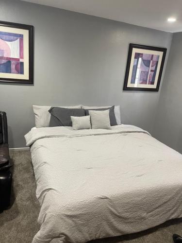 a bed in a bedroom with two pictures on the wall at Freeman Enterprises LLC in Las Vegas