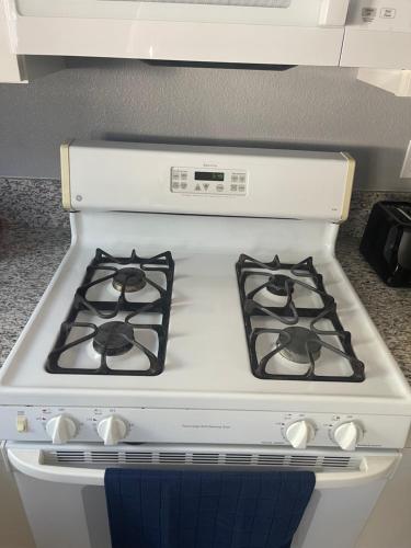 a white stove with two burners in a kitchen at Freeman Enterprises LLC in Las Vegas