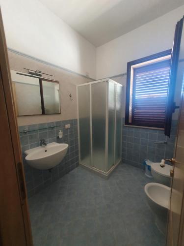 a bathroom with a sink and a shower and a toilet at Azzurro mare in Arenella