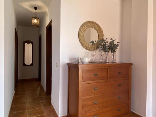 a dresser with a mirror on top of it in a hallway at V V El Cantil in Valverde