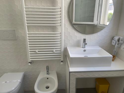 a bathroom with a sink and a toilet and a mirror at Mimi Leuca B&b in Leuca