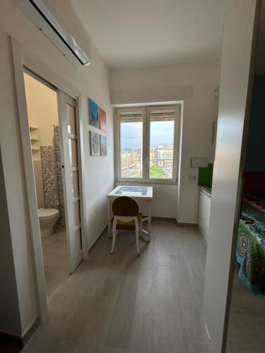 Cette petite chambre dispose d'une table et d'une fenêtre. dans l'établissement ViVa House Salerno, à Salerne
