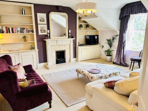 a living room with a couch and a fireplace at Ilkley Central Penthouse in Ilkley