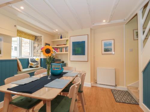 a dining room with a table and chairs at Holly Cottage in Yeovil