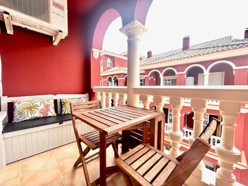 a balcony with a table and chairs on a building at Hispalis Mazagón Beach 303 in Mazagón