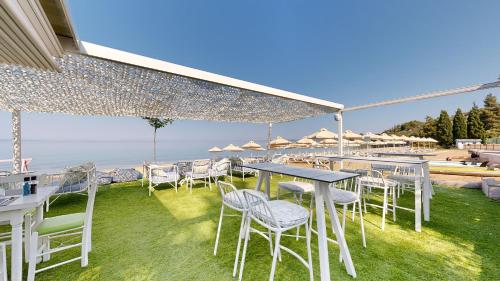 a table and chairs with a view of the ocean at Acrotel Lilyann Boutique Hotel in Elia