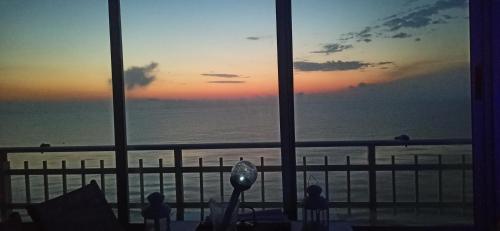 a view of the ocean from a hotel window at SUNSET ROOM AT FRONT BEACH - HABITACION EN LA PLAYA en Piso compartido in Tavernes de Valldigna