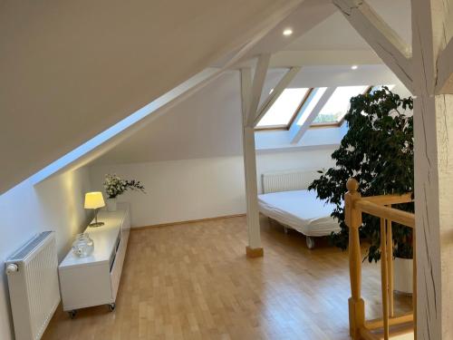 a attic room with a bed and a window at Apartament Przystań w Ustce - 120 m2 - 200 m od plaży Mickiewicza 2 in Ustka