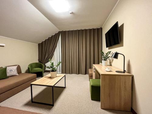 a living room with a couch and a tv in it at Blueberryhouse in Bukovel