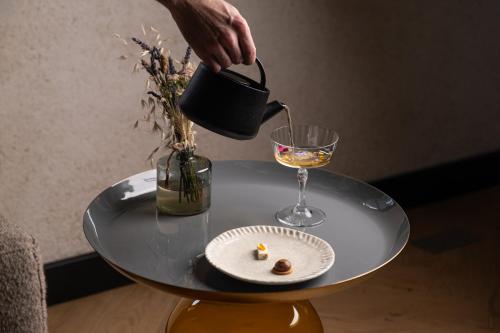 a person pouring a glass of wine on a table at Garenne in Livron-sur-Drôme