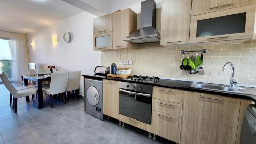 a kitchen with a sink and a stove top oven at 2 bedroom ground floor apartment in Kalogrea