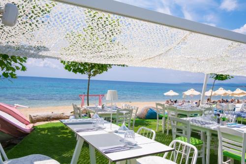 a restaurant with a view of the beach at Acrotel Lilyann Boutique Hotel in Elia