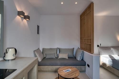 a small living room with a couch and a table at Clementina Paros in Naousa